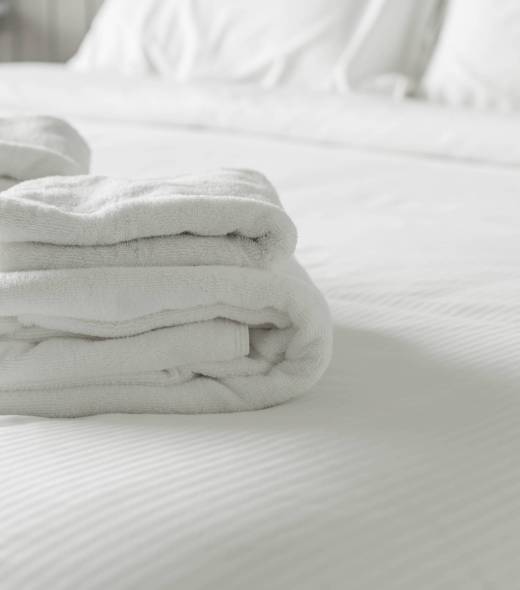 White towel on bed decoration in bedroom interior - Vintage light Filter